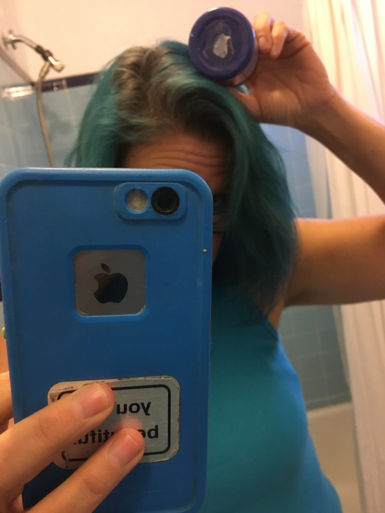 holding blue manic panic jar next to my blue hair