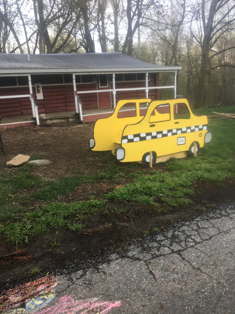 Play in Spring on a cartoon taxi at a summer camp lodge