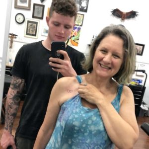 Mother and son at tattoo parlor