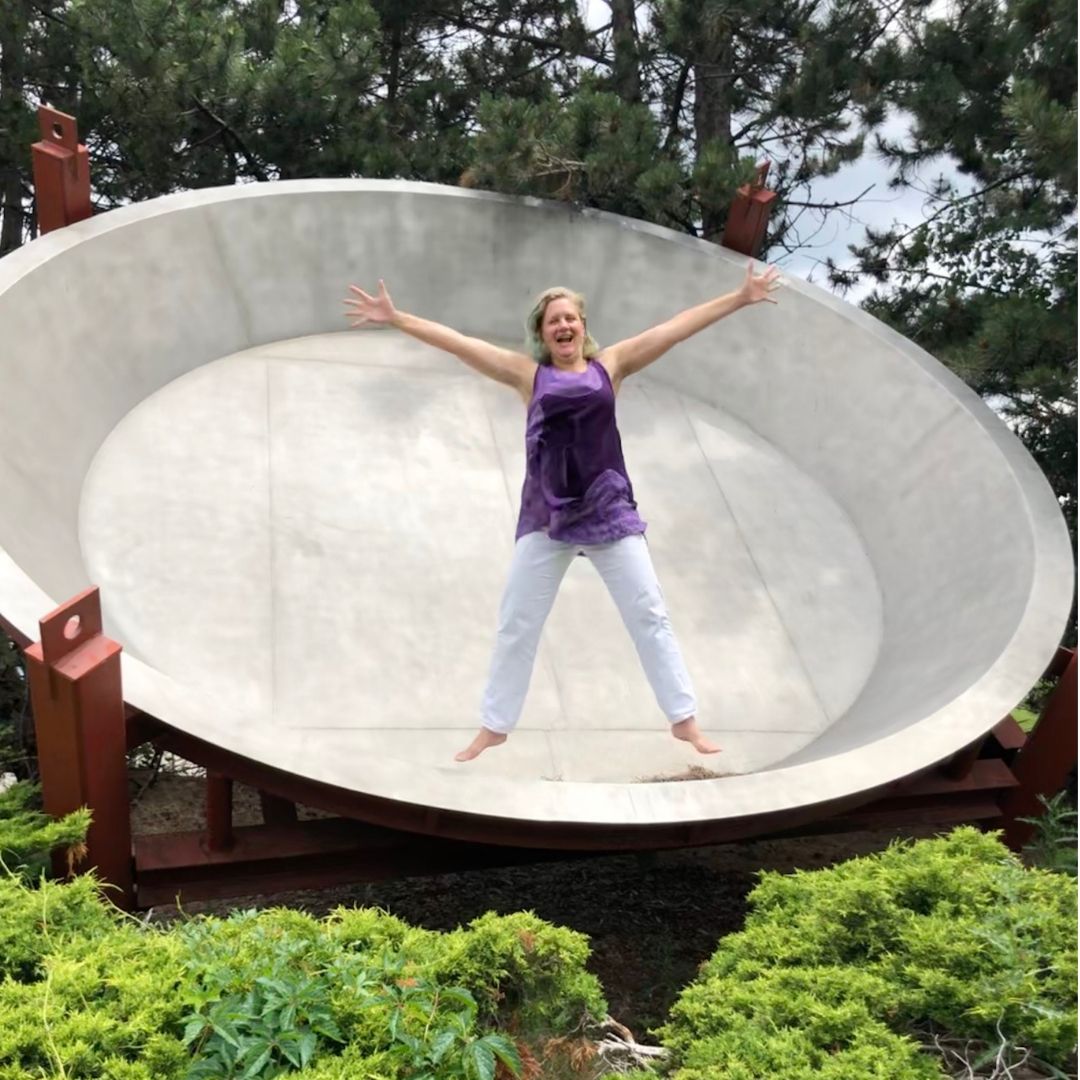 Stacey jumping inside the world's largest pie pan