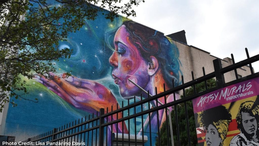 Mural of woman blowing into her hand