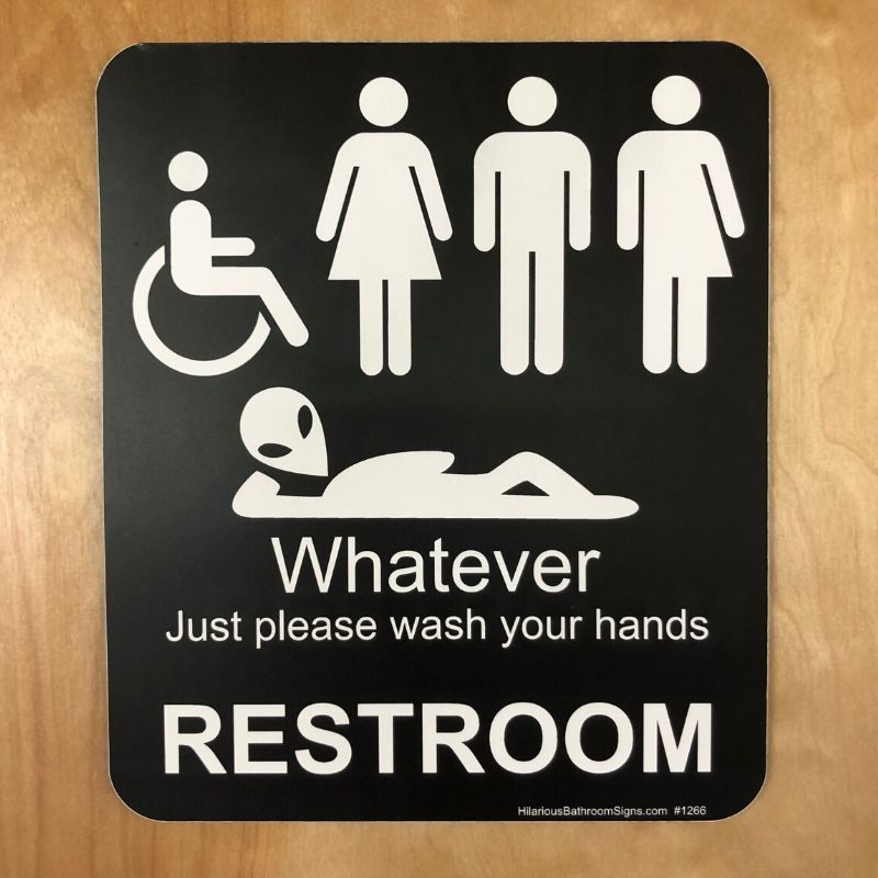 bathroom sign at the Tap Station featuring human figures and an alien