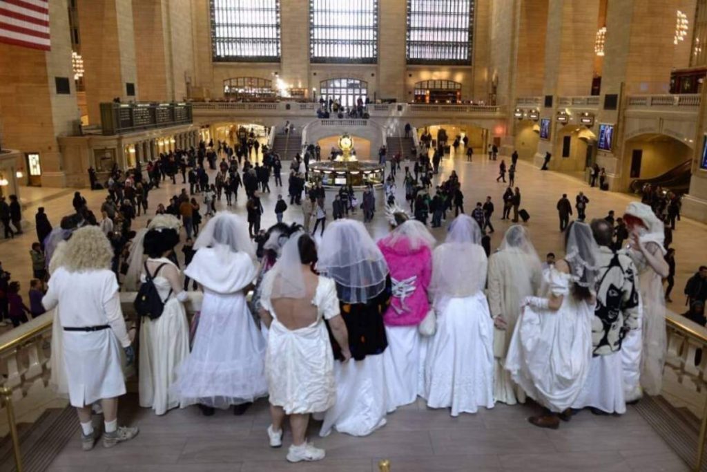 line of brides as seen from behind, overlooking crowd at Grand Central