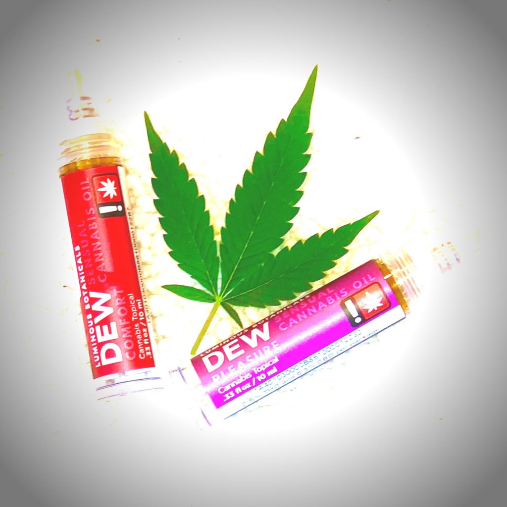 two vials of CDB/THC sex oils with marijuana leaf inbetween