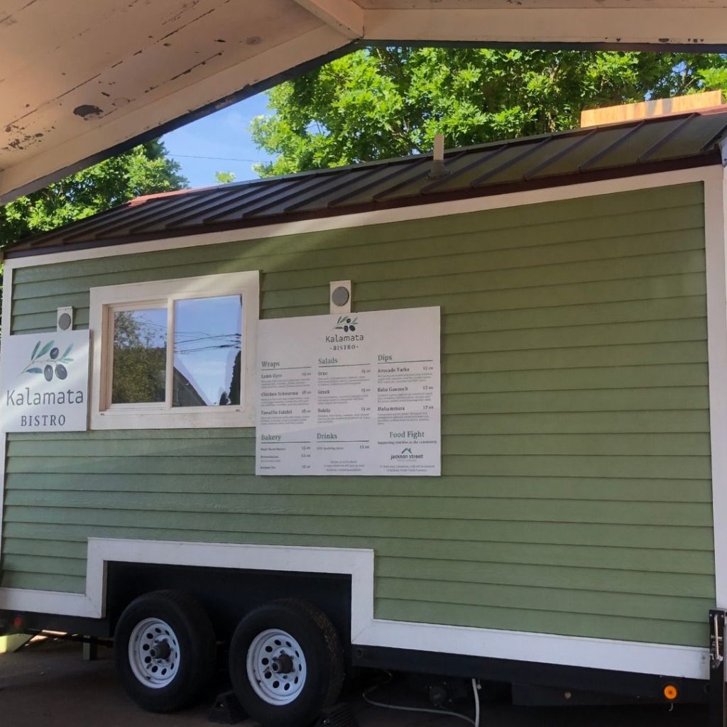 a green tiny house as food truck