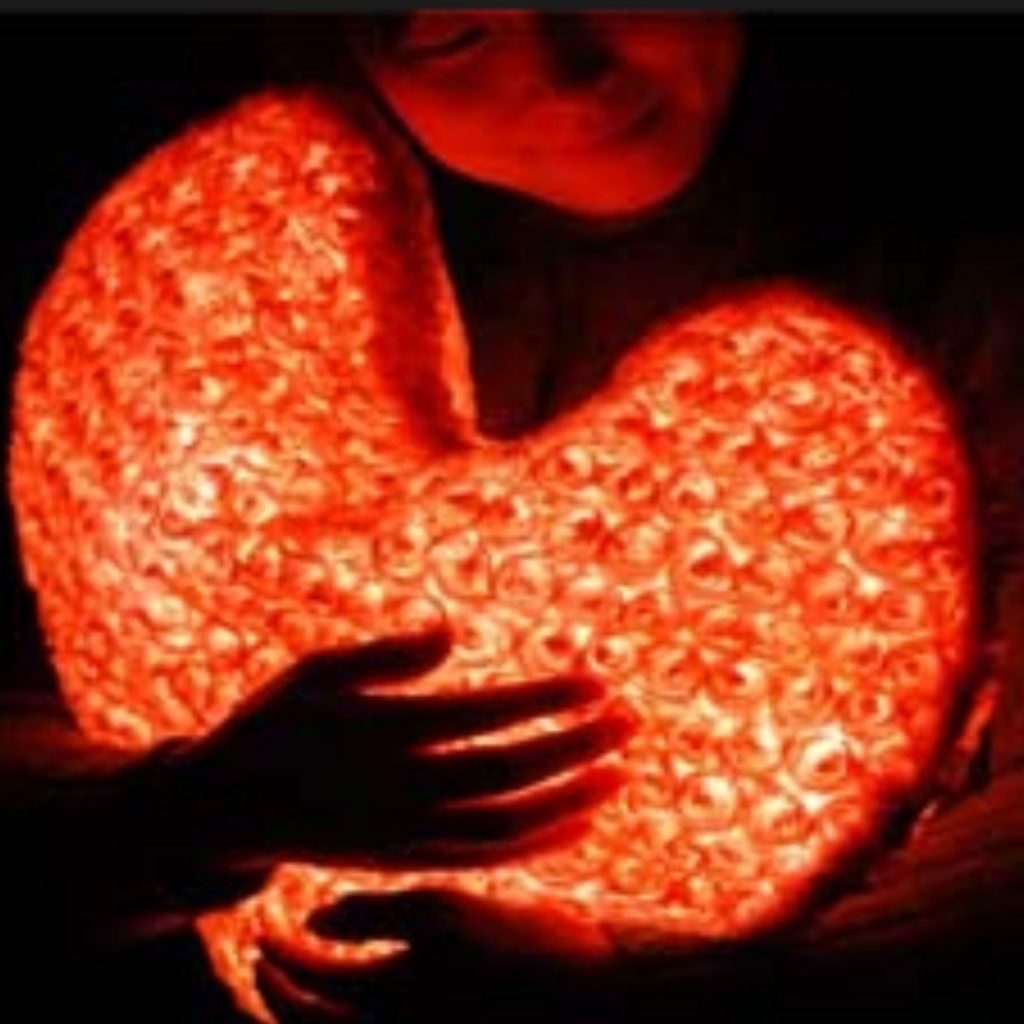 girl's head and hands holding glowing heart