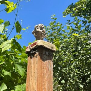Fence post with sculptures