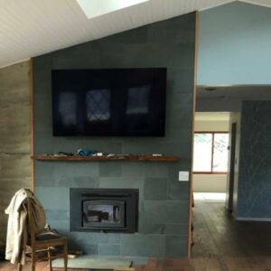 Fire place, TV on blue slate wall